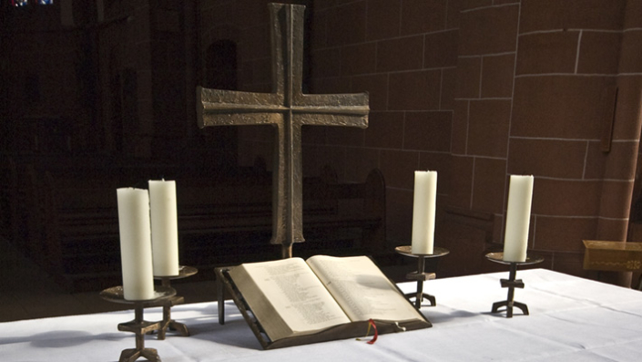 Altar with Bible, cross and four candles